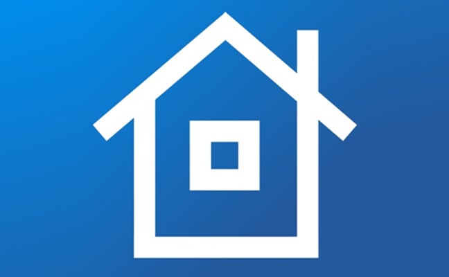 White house icon with pitched roof and window on blue background